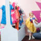 Photo of grandparent helping to get toddler into fancy dress.