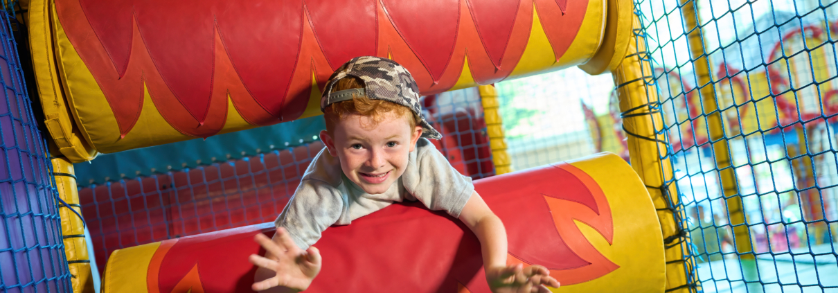 Photo of a child playing on the rollers in our playframe.