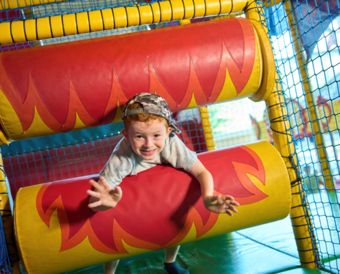 Photo of a child playing on the rollers in our playframe.