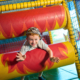 Photo of a child playing on the rollers in our playframe.
